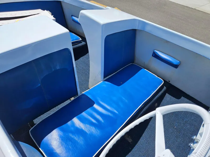 Slide: The Image of 1958 Larson Falls Flyer boat interior with blue seating and white accents. - 5