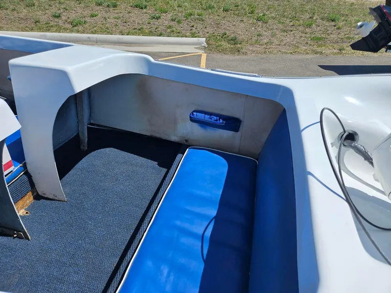 Slide: The Image of 1958 Larson Falls Flyer boat interior with blue seating and carpet. - 6