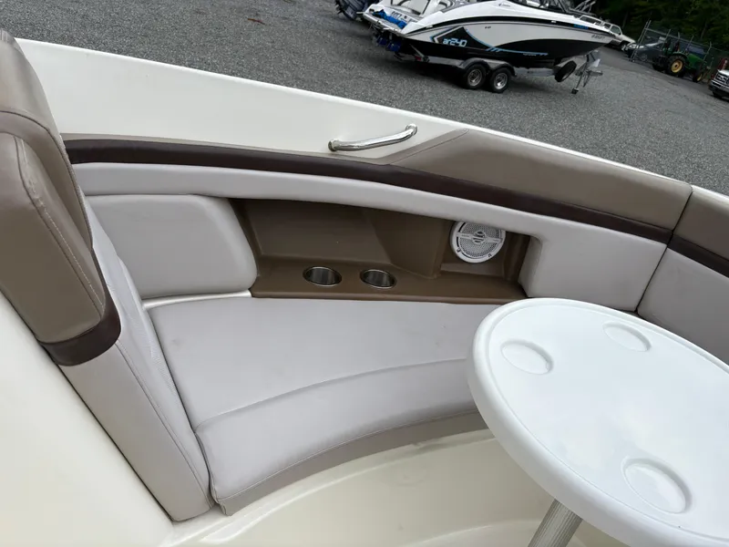 Slide: The Image of Interior seating of a 2011 Sea Ray 270 SLX boat with cup holders and table. - 30