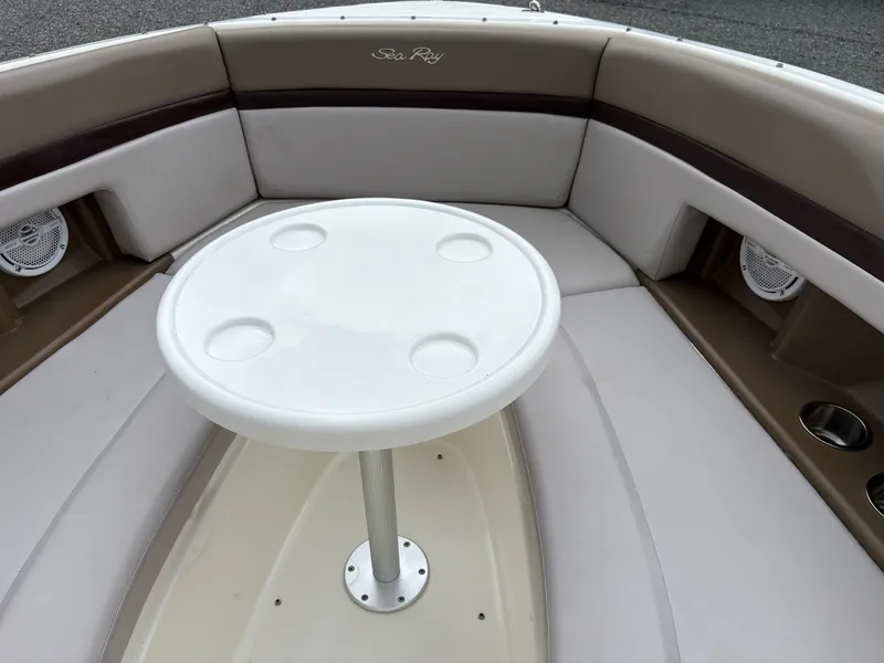 Slide: The Image of 2011 Sea Ray 270 SLX boat interior with round table and cushioned seating. - 31