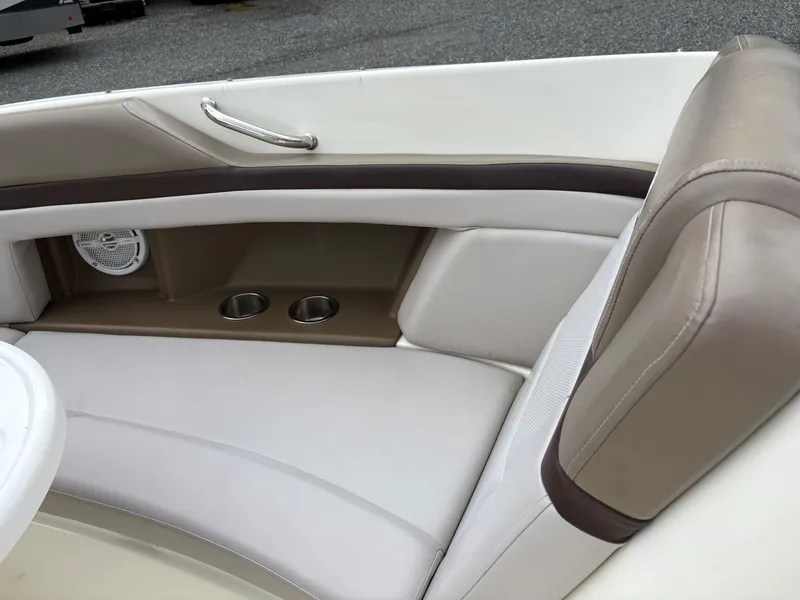 Slide: The Image of 2011 Sea Ray 270 SLX boat interior with cushioned seating and cup holders. - 32