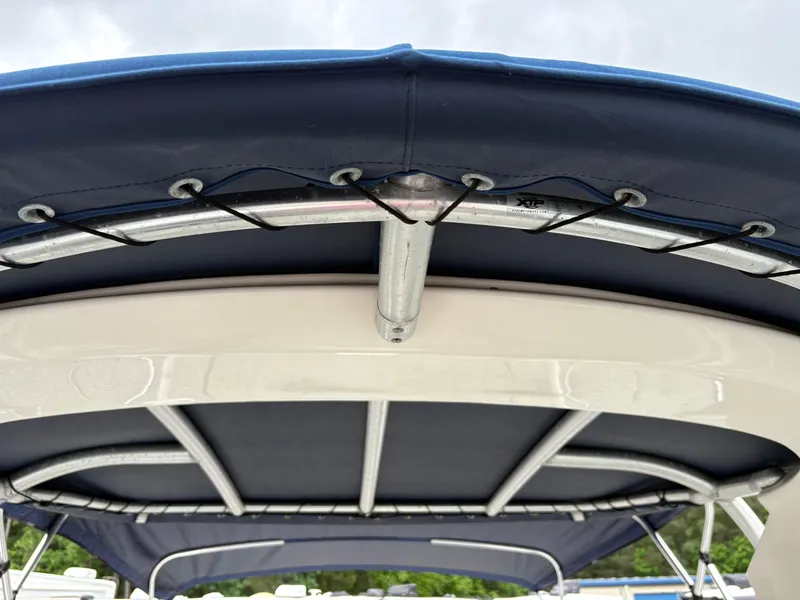 Slide: The Image of Bimini top of a 2011 Sea Ray 270 SLX boat with metal frame and blue fabric. - 33