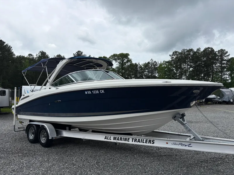Slide: The Image of 2011 Sea Ray 270 SLX boat on trailer, parked outdoors under cloudy sky. - 6
