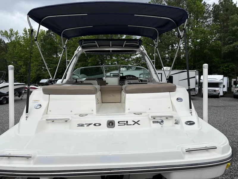 Slide: The Image of 2011 Sea Ray 270 SLX boat with canopy, rear view in outdoor setting. - 8