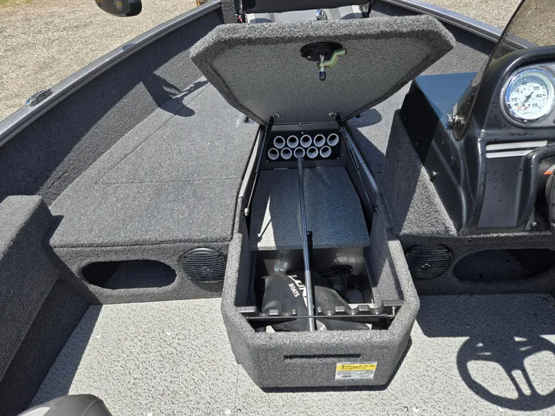 Slide: The Image of 2022 Lund 1775 Adventure SS boat interior with open storage compartment and dashboard view. - 10