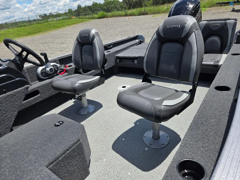 Slide: The Image of 2022 Lund 1775 Adventure SS boat interior with two gray seats and steering wheel. - 12