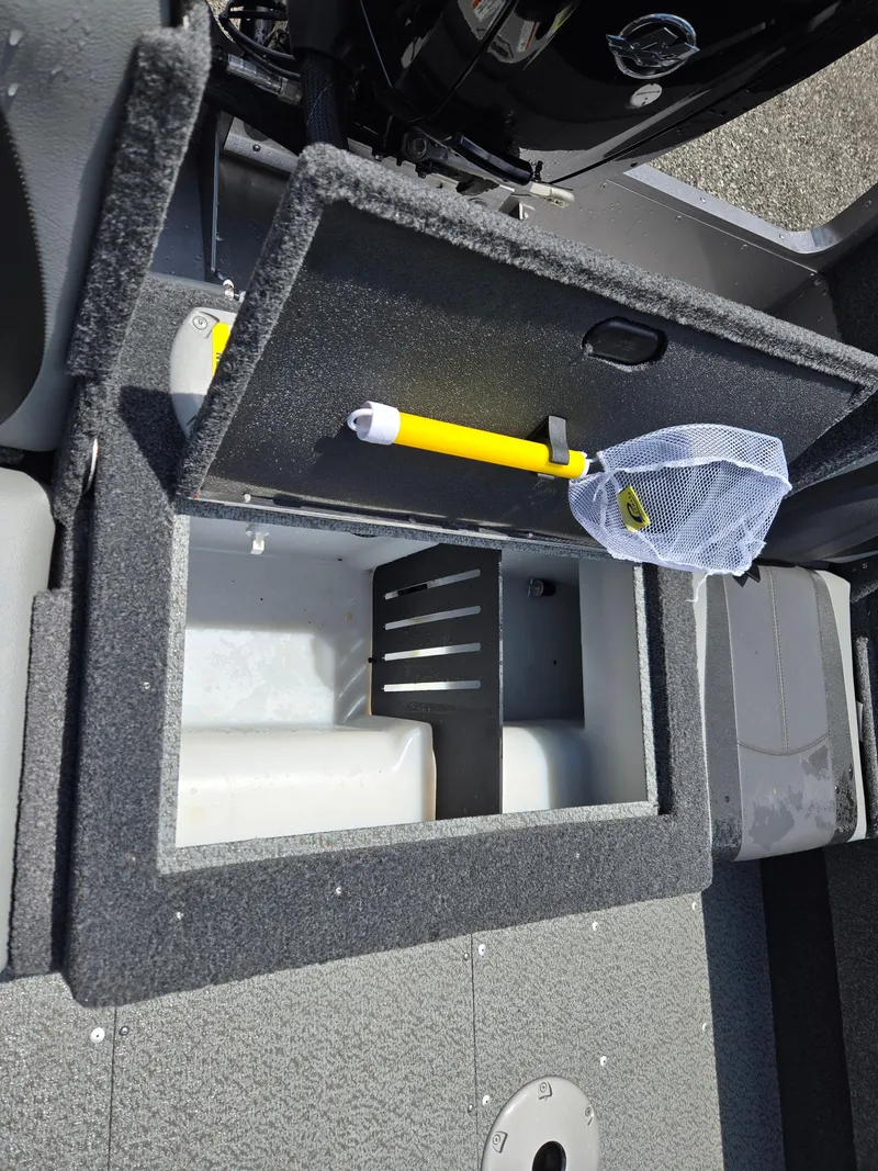 Slide: The Image of 2022 Lund 1775 Adventure SS boat storage compartment with open lid and fishing net. - 14