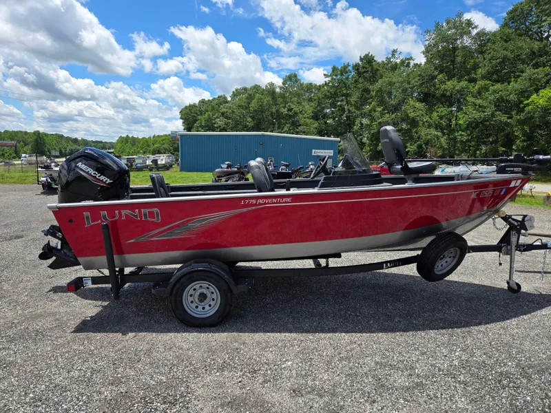 Slide: The Image of 2022 Lund 1775 Adventure SS boat on trailer, red exterior, parked outdoors. - 3