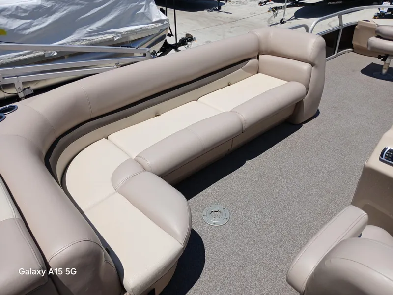 Slide: The Image of 2015 Sun Tracker Fishin Barge 24 DLX with beige seating on deck. - 8