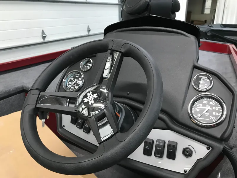 Slide: The Image of 2025 Ranger RT178C boat dashboard with steering wheel and gauges. - 3