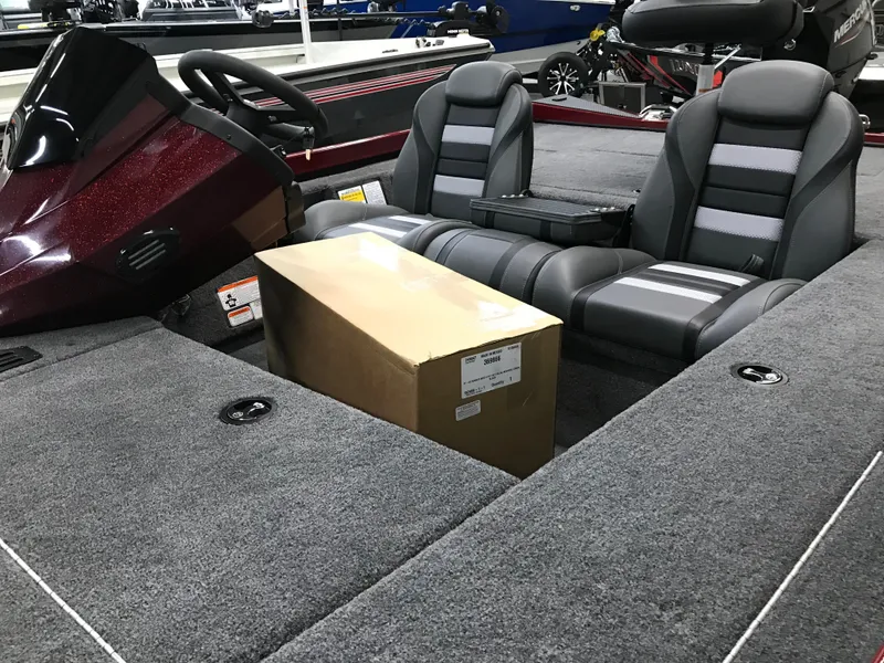 Slide: The Image of 2025 Ranger RT178C boat interior with dual seats and a cardboard box. - 9