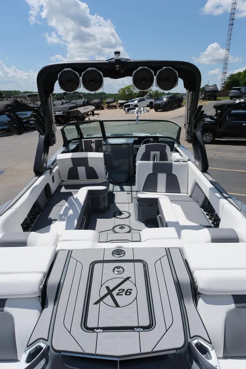 Slide: The Image of 2025 MasterCraft X26 boat with sleek design and spacious seating under a clear blue sky. - 10
