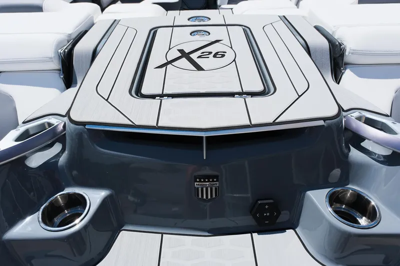 Slide: The Image of 2025 MasterCraft X26 boat deck with sleek design and integrated cup holders. - 11