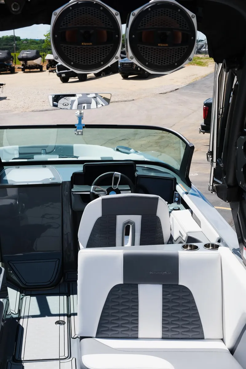 Slide: The Image of 2025 MasterCraft X26 boat interior with sleek seating and advanced audio system. - 12