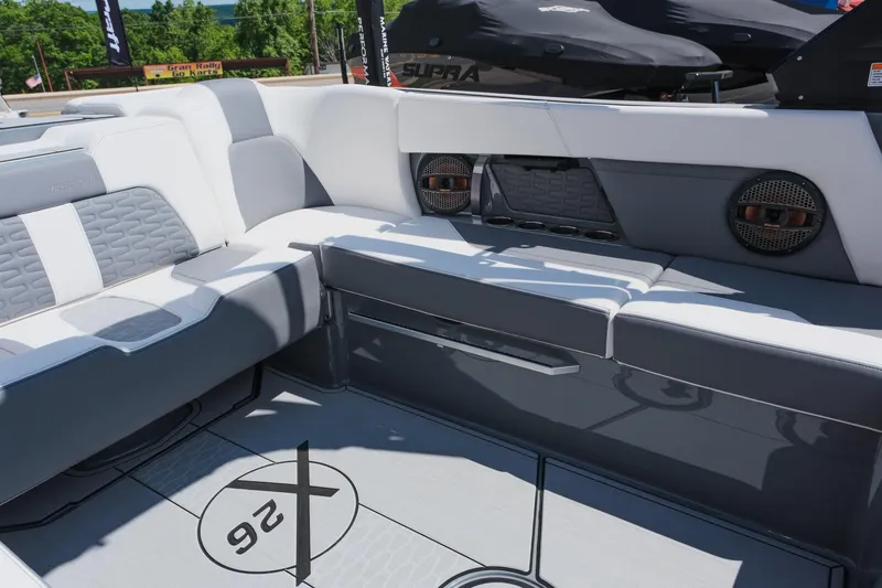 Slide: The Image of 2025 MasterCraft X26 boat interior with gray seating and modern design. - 14