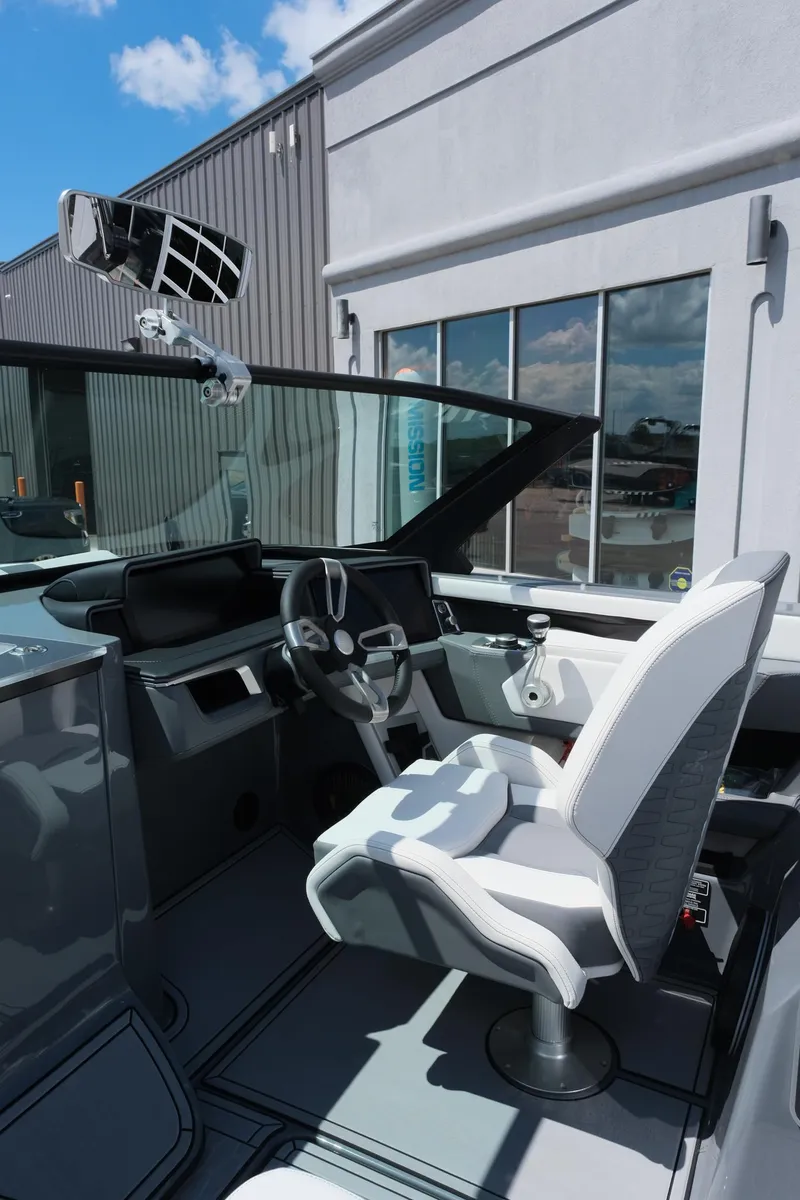 Slide: The Image of 2025 MasterCraft X26 boat interior with modern steering and seating. - 19