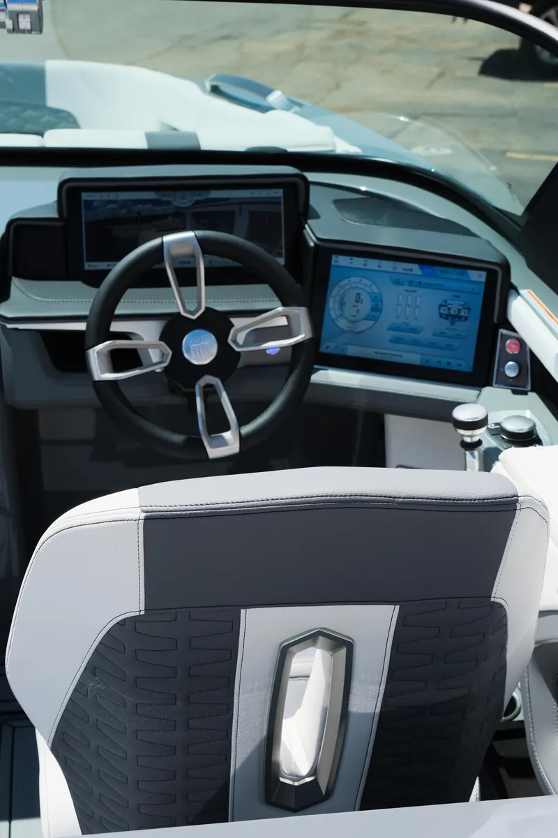 Slide: The Image of 2025 MasterCraft X26 boat cockpit with modern steering wheel and digital displays. - 20