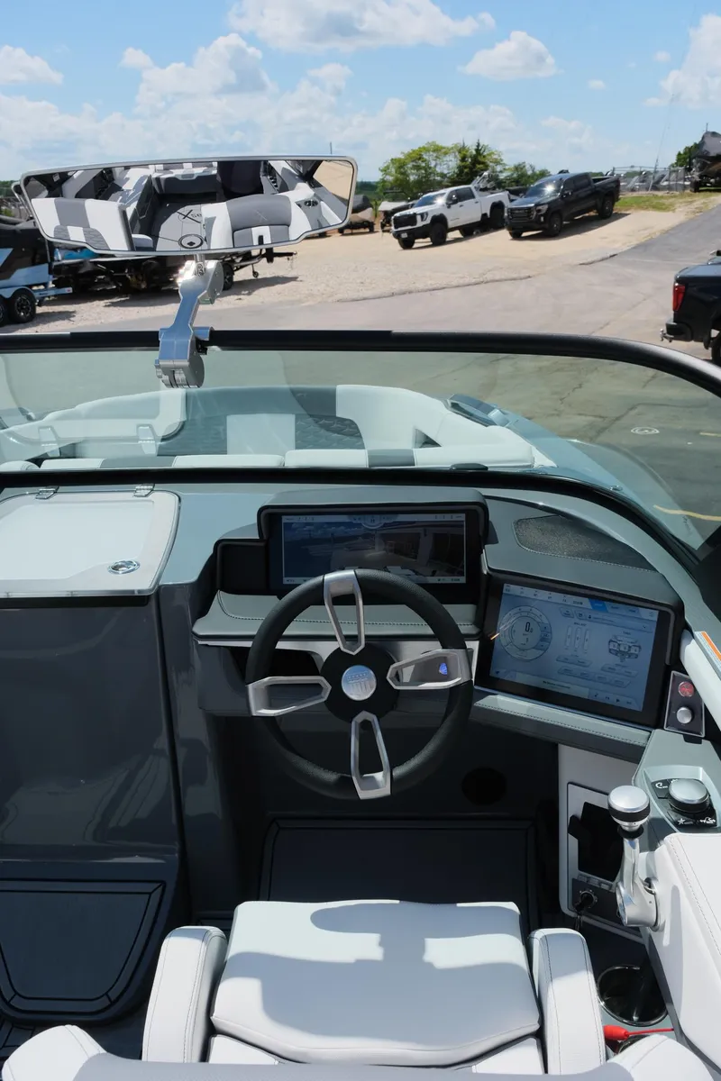Slide: The Image of 2025 MasterCraft X26 boat cockpit with modern steering and digital displays. - 21