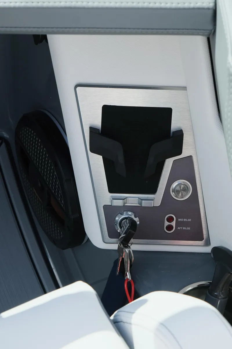 Slide: The Image of 2025 MasterCraft X26 boat dashboard with key ignition and control panel. - 23