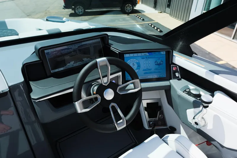 Slide: The Image of 2025 MasterCraft X26 boat cockpit with modern steering wheel and digital displays. - 24
