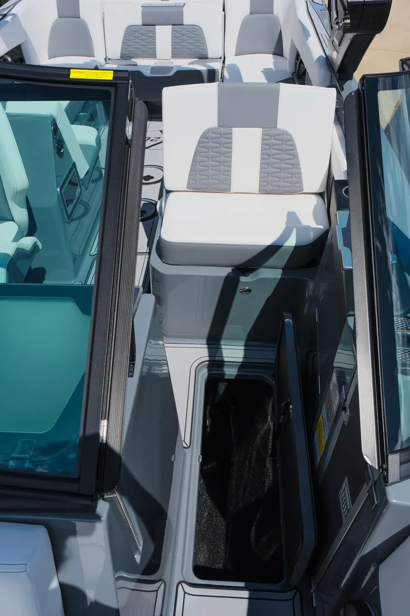Slide: The Image of 2025 MasterCraft X26 boat interior with open storage compartment and seating. - 31