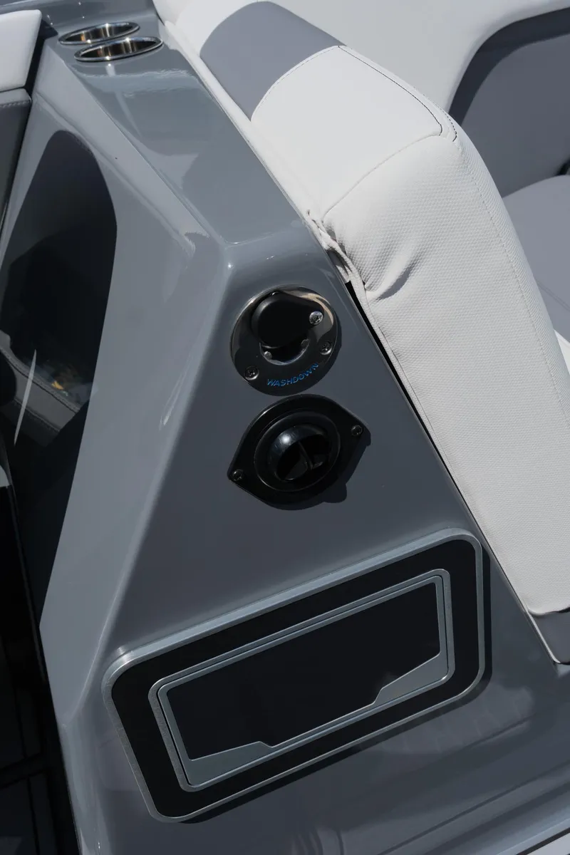 Slide: The Image of 2025 MasterCraft X26 boat interior with sleek gray and white seating and audio controls. - 34