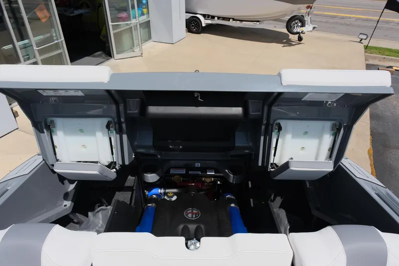 Slide: The Image of 2025 MasterCraft X26 boat engine compartment with open hatches, showcasing modern design and components. - 37