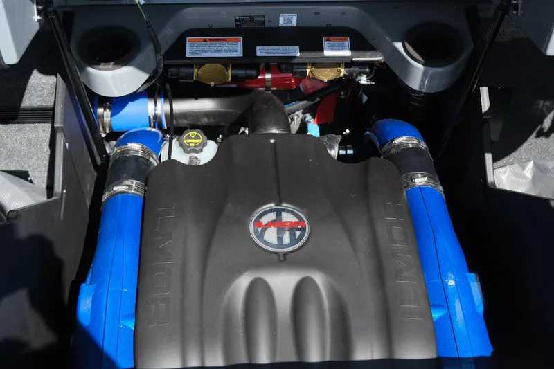 Slide: The Image of 2025 MasterCraft X26 engine with blue hoses and branded cover. - 38