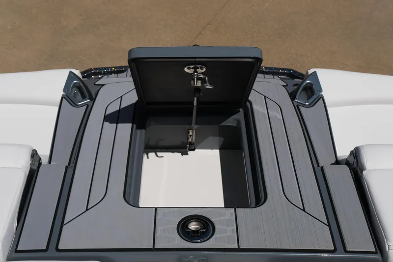 Slide: The Image of 2025 MasterCraft X26 boat storage compartment with open hatch, showcasing sleek design and functionality. - 39