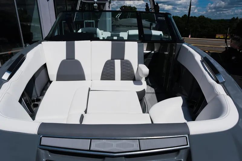 Slide: The Image of 2025 MasterCraft X26 boat interior with white and gray seating, showcasing luxury design. - 47