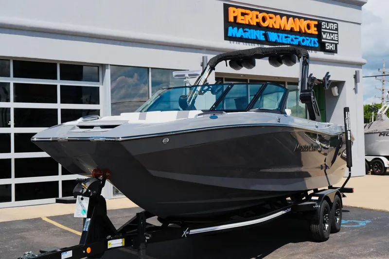 Slide: The Image of 2025 MasterCraft X26 boat on trailer at Performance Marine Watersports dealership. - 49