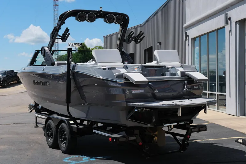 Slide: The Image of 2025 MasterCraft X26 boat on trailer, sleek design, gray exterior, parked outdoors. - 5