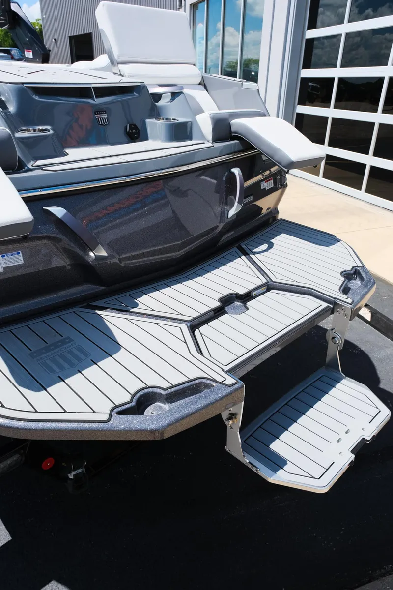 Slide: The Image of 2025 MasterCraft X26 boat with sleek swim platform and modern design. - 7