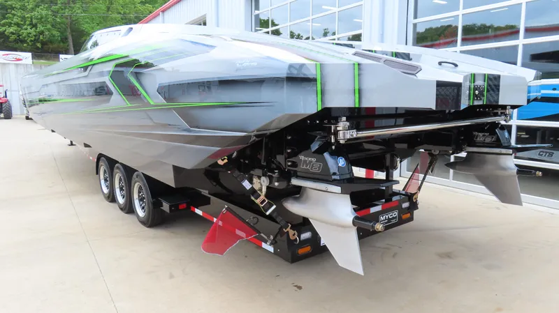 Slide: The Image of 2025 Outerlimits 46 SC powerboat on trailer, showcasing sleek design and triple-axle setup. - 12