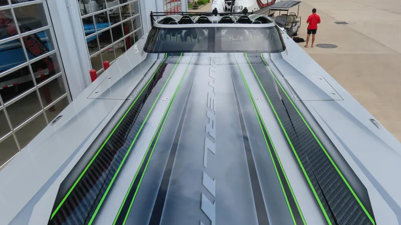 Slide: The Image of 2025 Outerlimits 46 SC boat with sleek design and vibrant green accents. - 14