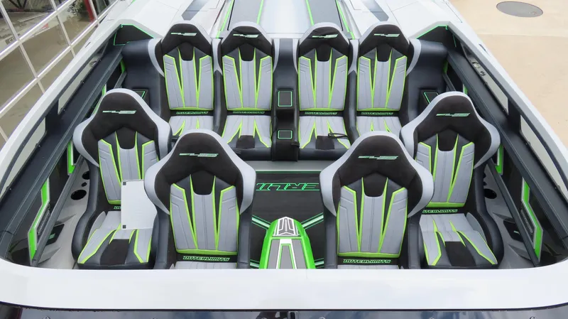 Slide: The Image of 2025 Outerlimits 46 SC boat interior with sleek, modern seating in black, white, and green accents. - 15