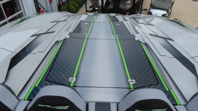Slide: The Image of 2025 Outerlimits 46 SC boat deck with sleek design and green accents. - 16