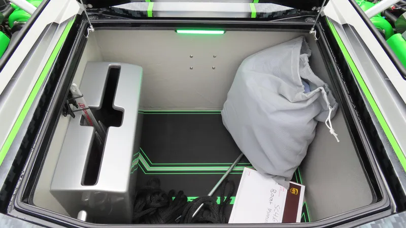 Slide: The Image of Storage compartment of 2025 Outerlimits 46 SC boat with organized items. - 28