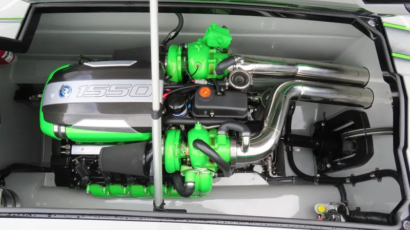 Slide: The Image of Engine of 2025 Outerlimits 46 SC boat, featuring green components and chrome exhaust pipes. - 32