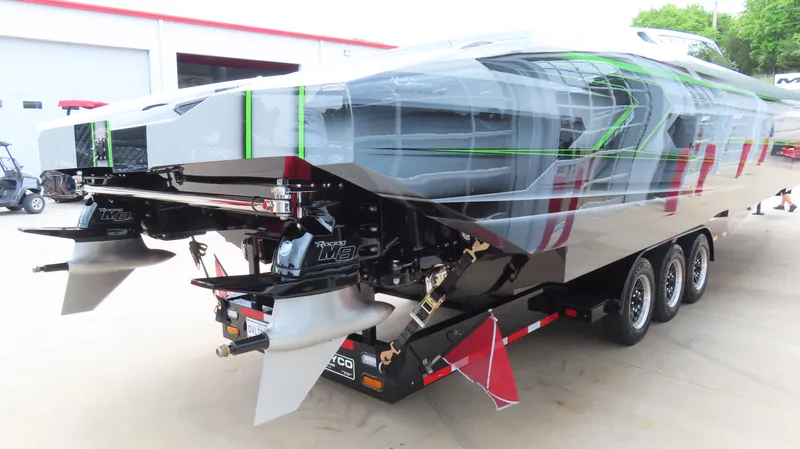 Slide: The Image of 2025 Outerlimits 46 SC powerboat with sleek design and triple-axle trailer. - 8