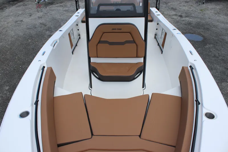 Slide: The Image of 2025 Sea Pro 245 FLX boat interior with tan seating and white deck. - 15