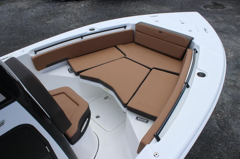 Slide: The Image of 2025 Sea Pro 245 FLX boat with tan cushioned seating in the bow area. - 17