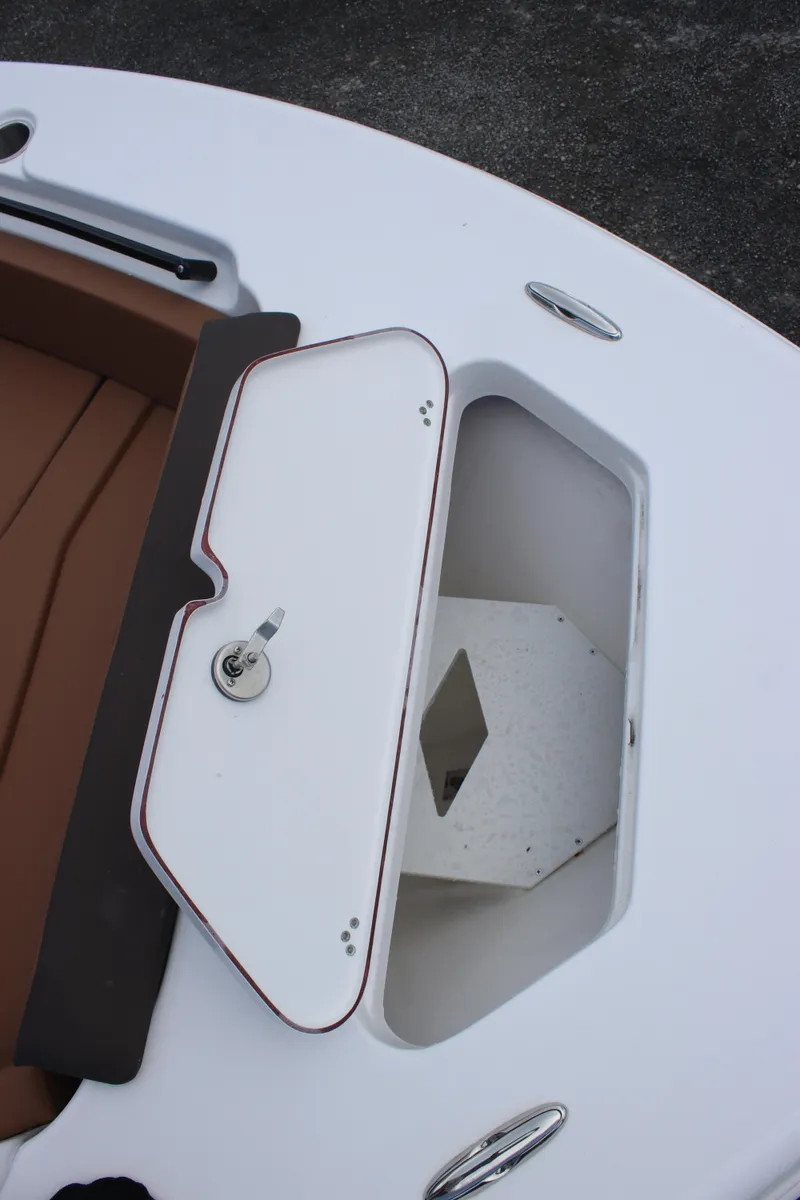 Slide: The Image of 2025 Sea Pro 245 FLX boat storage compartment with open hatch, showcasing interior space. - 18