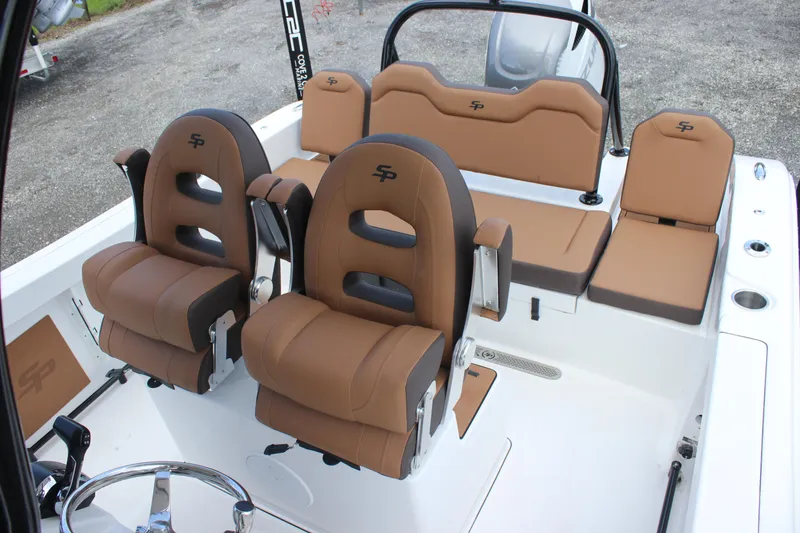 Slide: The Image of 2025 Sea Pro 245 FLX boat interior with brown seating and modern design. - 19