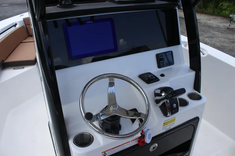 Slide: The Image of 2025 Sea Pro 245 FLX boat console with steering wheel and navigation display. - 20