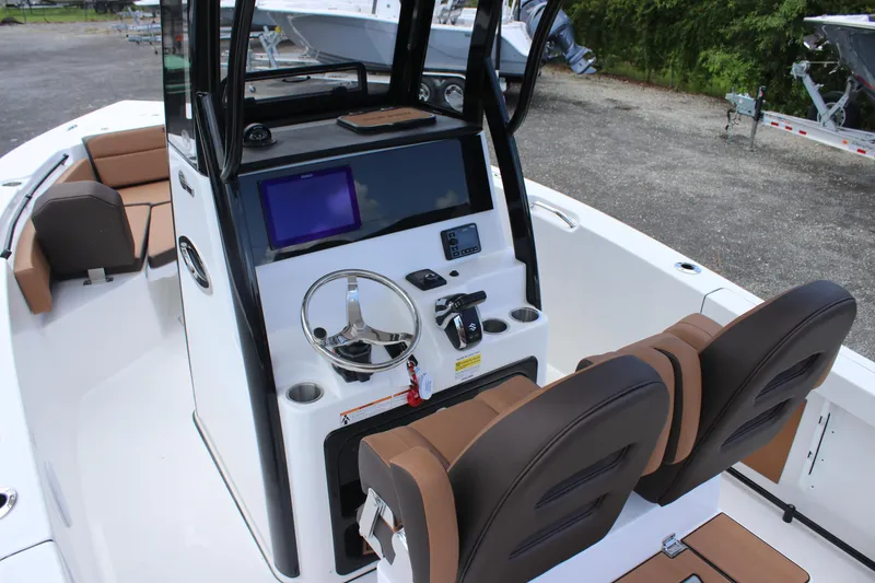 Slide: The Image of 2025 Sea Pro 245 FLX boat interior with modern console and seating. - 25
