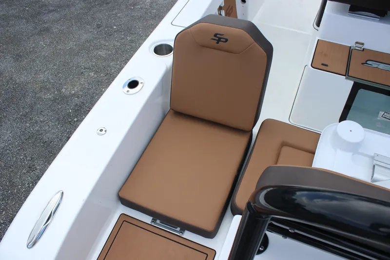 Slide: The Image of 2025 Sea Pro 245 FLX boat seat with brown cushions and storage compartments. - 28
