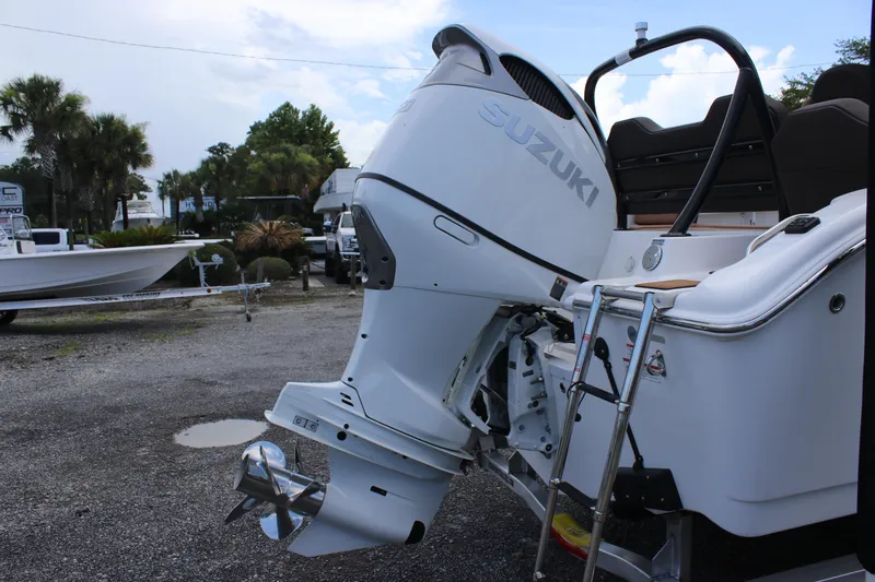 Slide: The Image of 2025 Sea Pro 245 FLX boat with Suzuki outboard motor in a marina setting. - 29