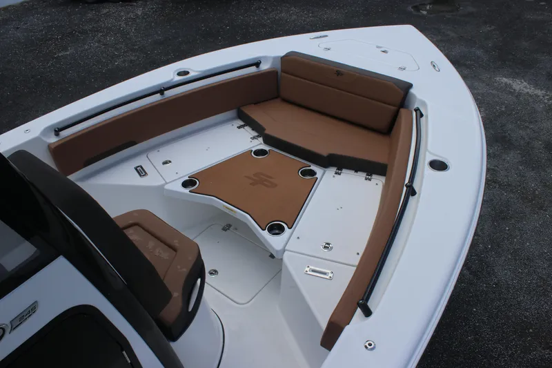 Slide: The Image of 2025 Sea Pro 245 FLX boat interior with brown seating and white deck. - 8