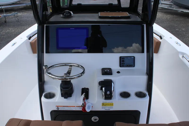 Slide: The Image of 2025 Sea Pro 245 FLX boat dashboard with steering wheel and control panel. - 9